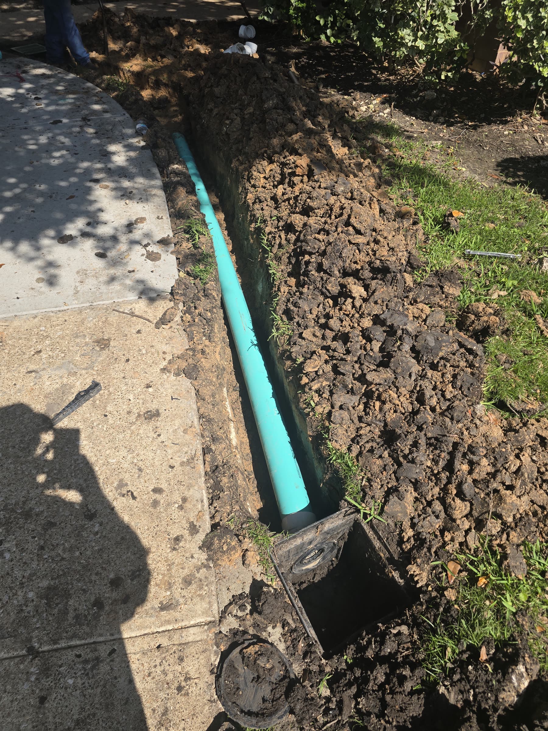 French drain installation with PVC pipe and catch basin in Greater Houston